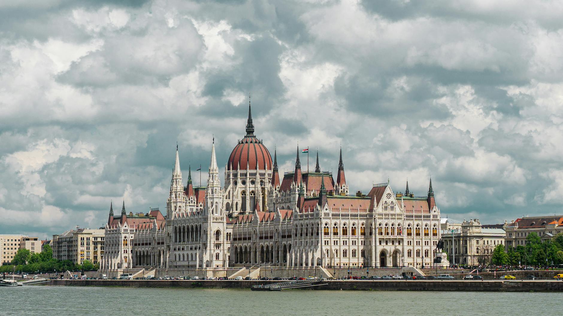 building near body of water under cloudy sky